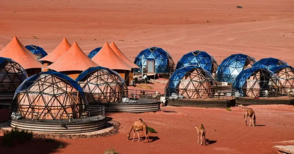 Tiendas domo de lujo en el desierto marroquí con camellos pastando
