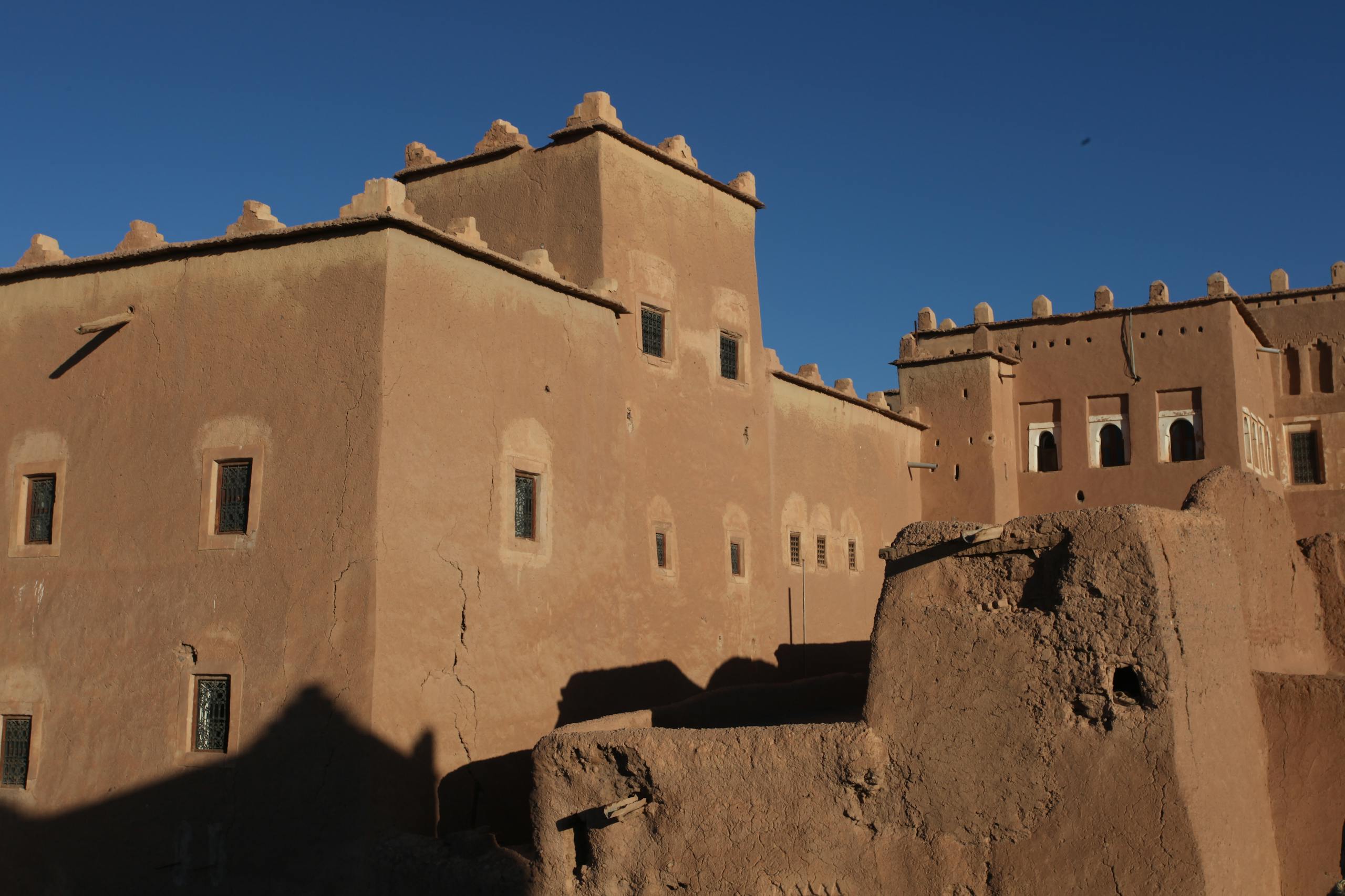 Discover the historical mud-brick architecture of Taourirt Kasbah in Ouarzazate, Morocco.