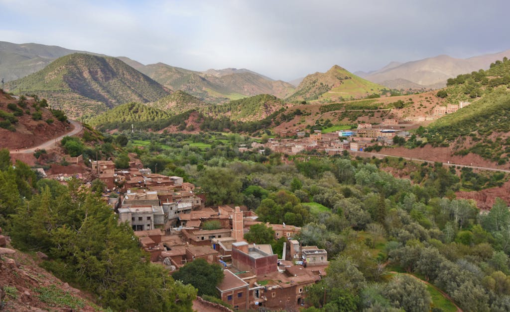 Scenic aerial view of Ait Barka village amidst lush green valleys and rugged mountains.