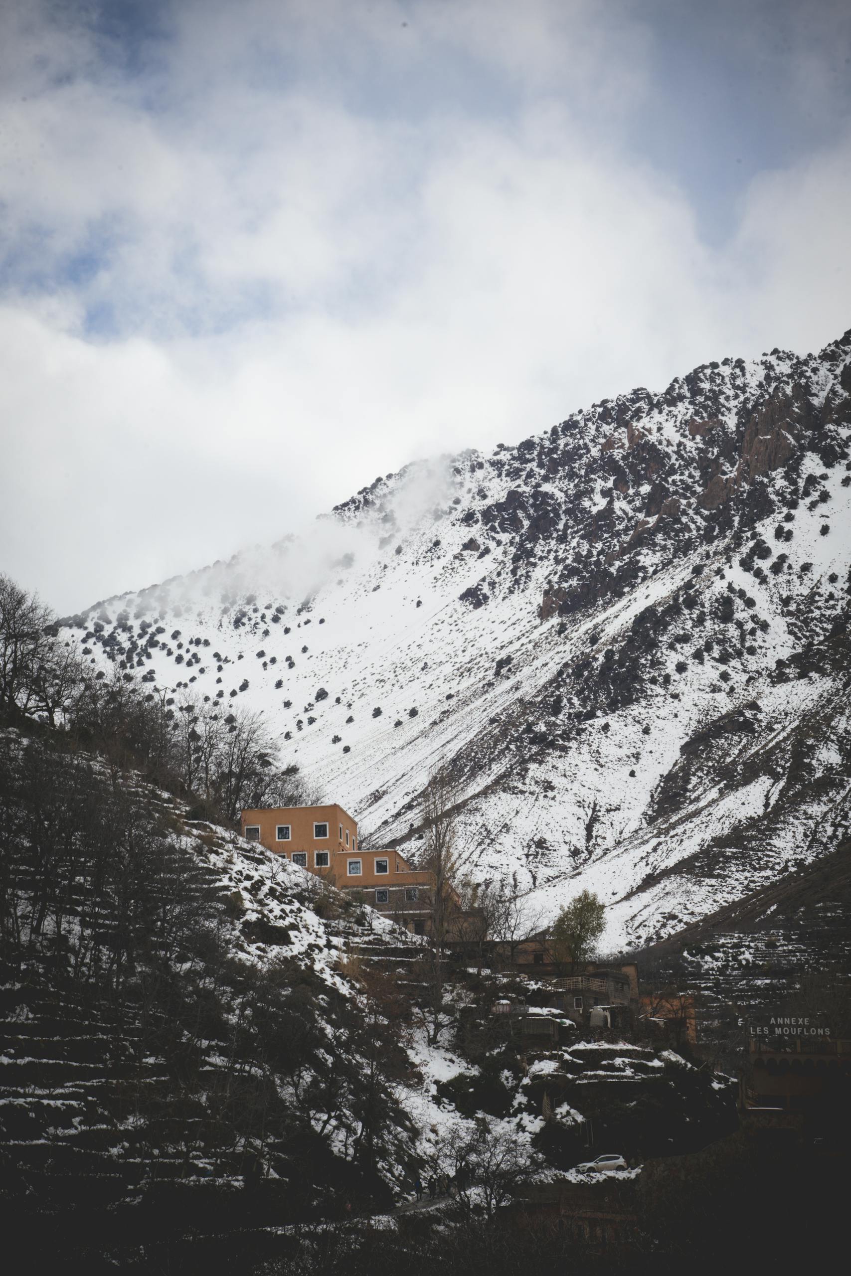 Scenic winter landscape of a snowy mountain village in Imlil, Morocco.