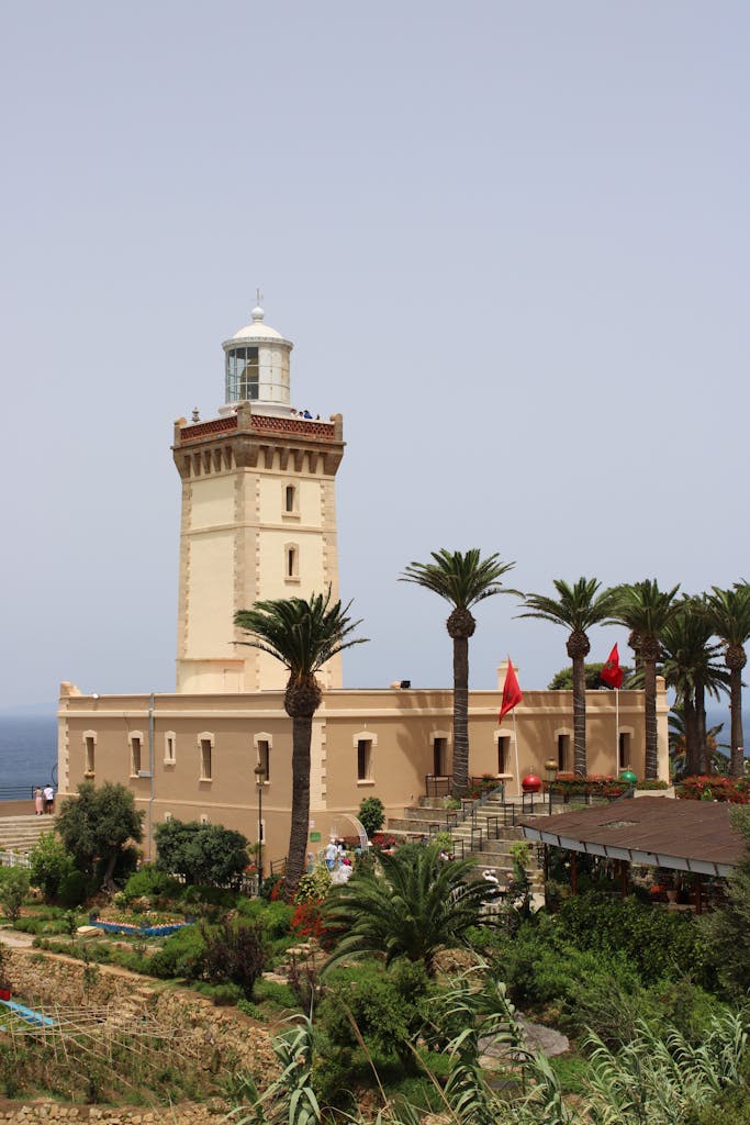 Stunning view of Cape Spartel Lighthouse with palm trees in Tangier, Morocco.